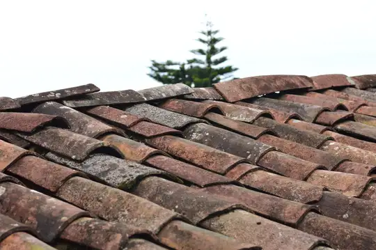 Close-up of textured brown roof shingles, a stone-coated tile style