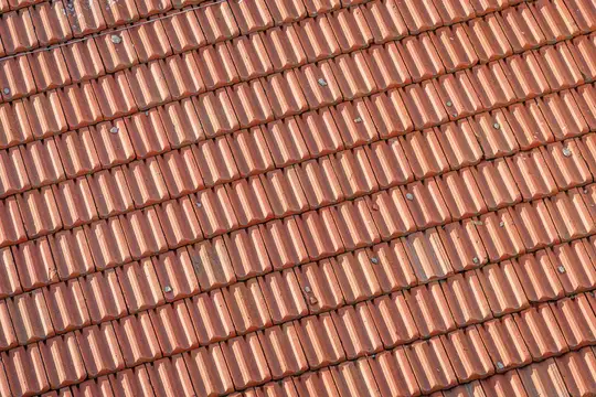 Close-up of overlapping red tile-profile roofing, a roman/euro tile mabati style