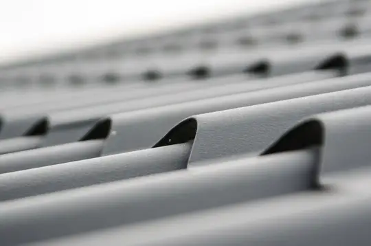 Close-up of grey metal roofing sheets, a box-profile style